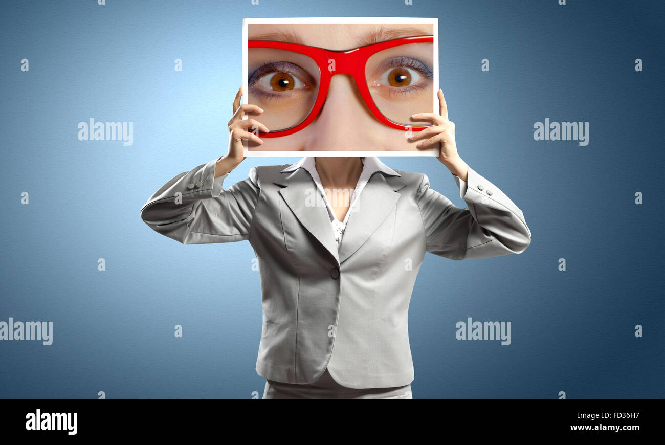 Unrecognisable Image Unrecognizable businesswoman holding big photo with eyes Stock Photo ...