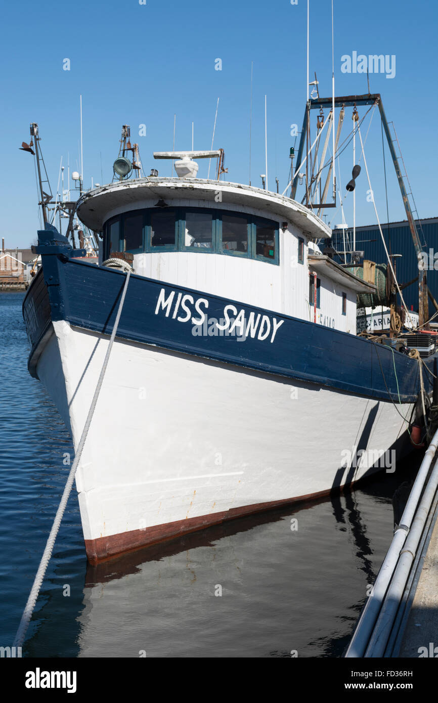 Gloucester, MA, USA — March 22,2015—MIss Sandy, a wooden lobster boat at its pier in the harbor