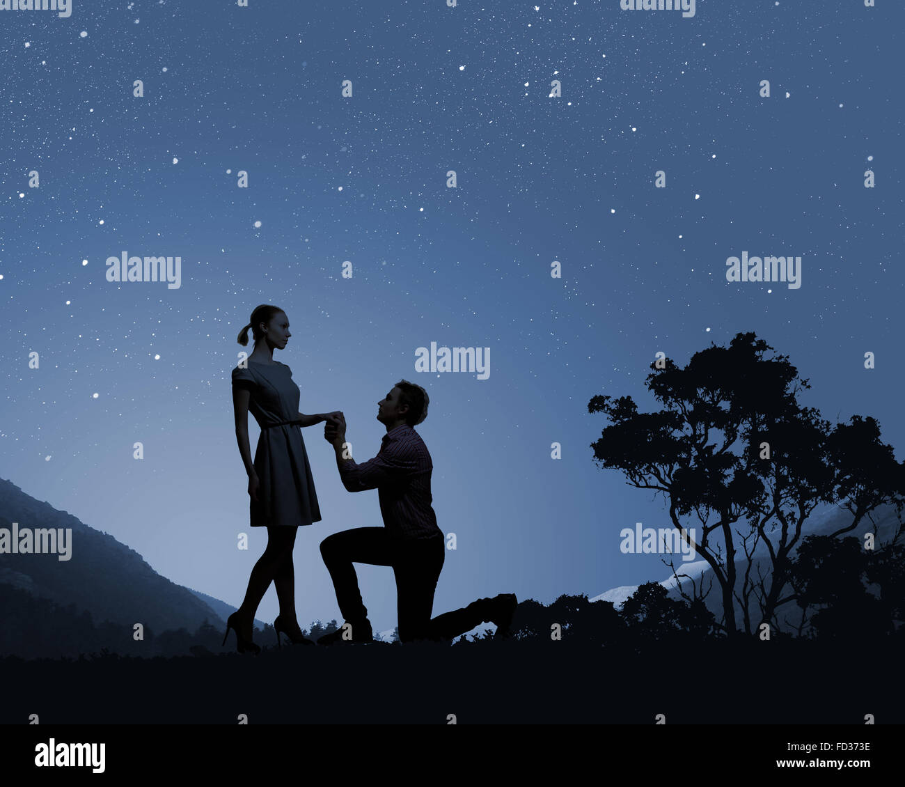 Silhouettes of romantic couple under the moon light Stock Photo - Alamy