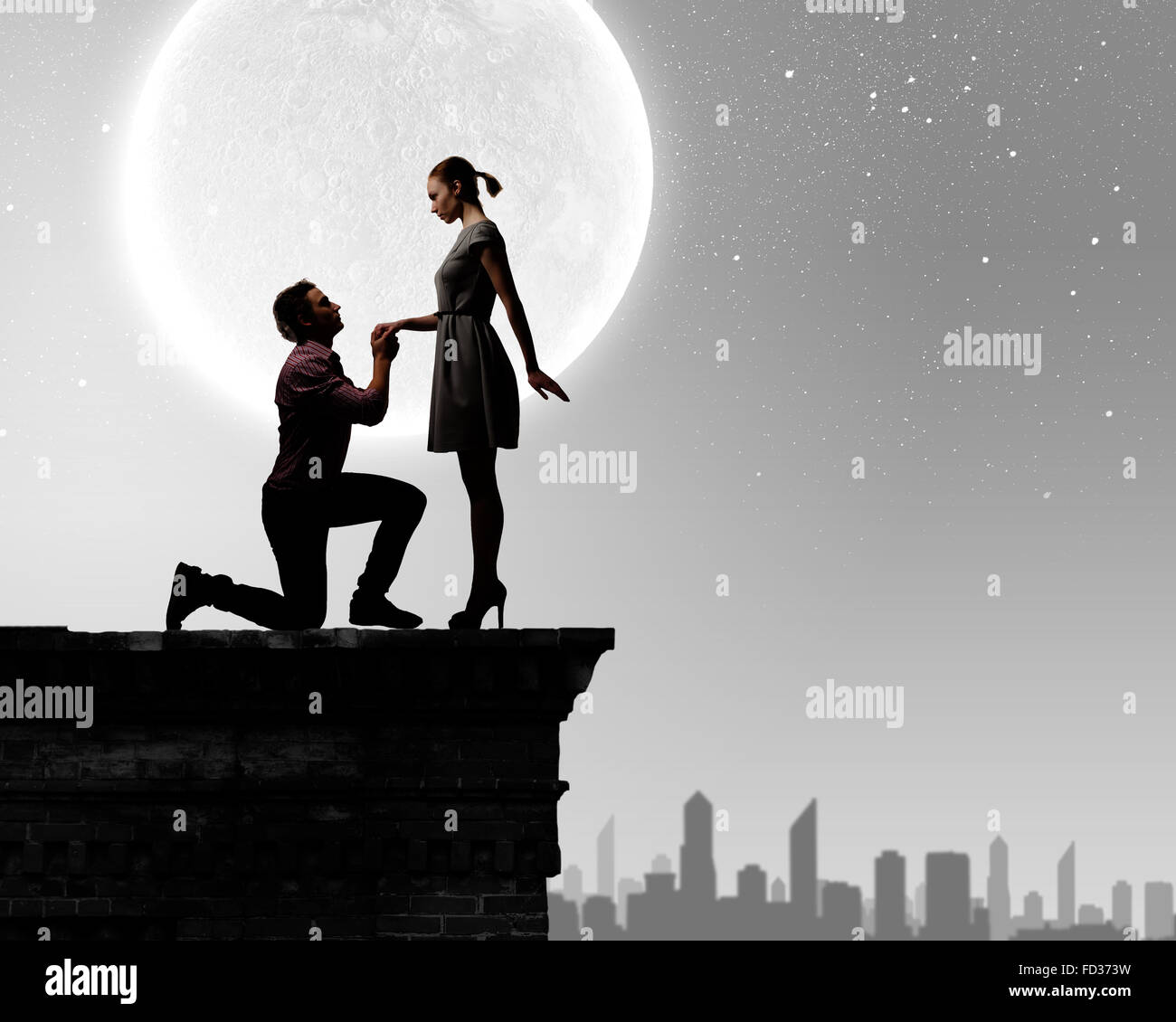 Silhouettes of romantic couple under the moon light Stock Photo - Alamy