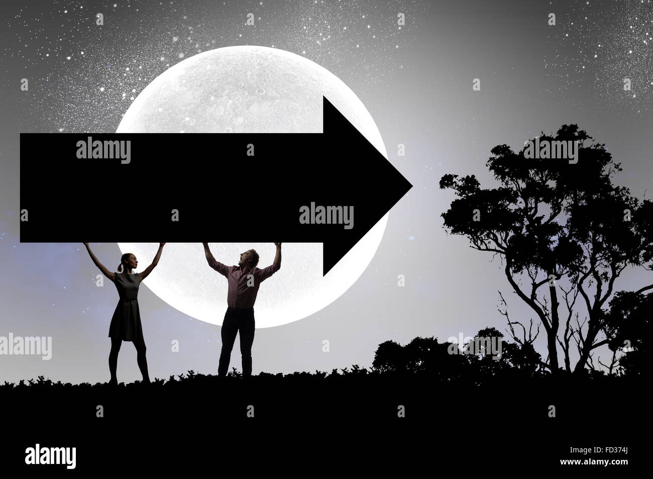Silhouettes of young couple holding black arrow banner Stock Photo - Alamy