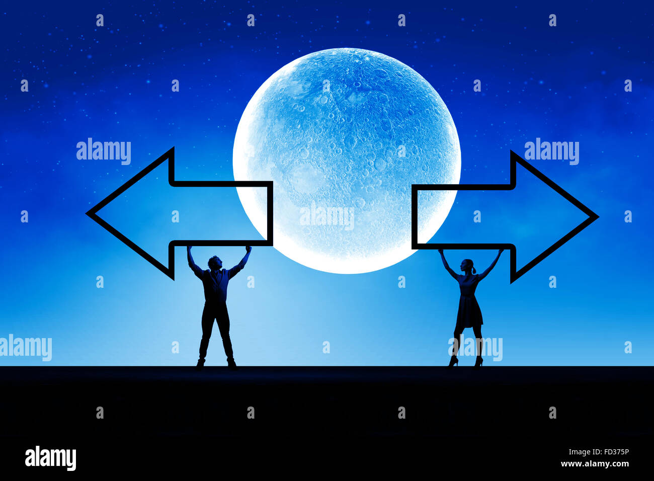 Silhouettes of young couple holding black arrow banner Stock Photo - Alamy