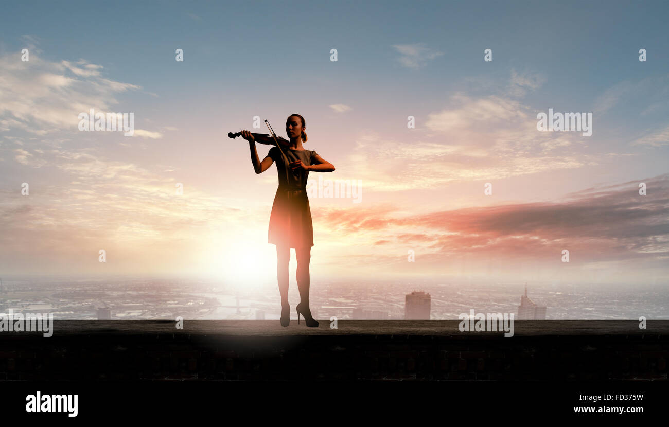 Silhouette of woman playing violin at sunrise Stock Photo - Alamy