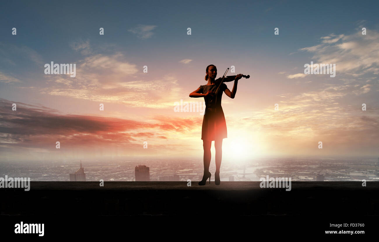 Silhouette of woman playing violin at sunrise Stock Photo - Alamy