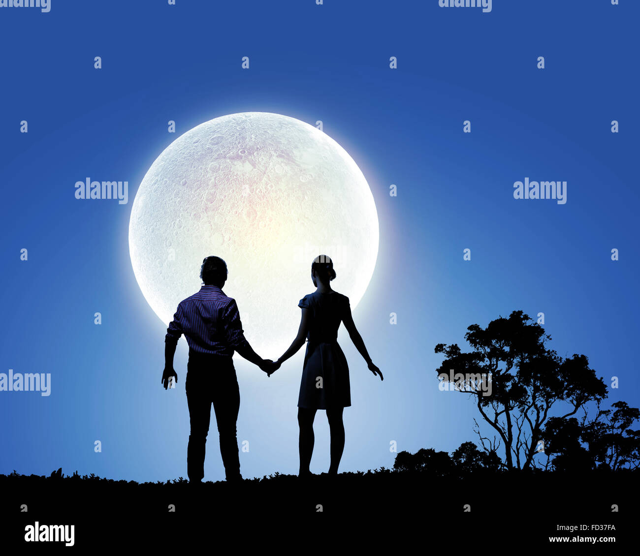 Silhouettes of young romantic couple standing under the moon light ...