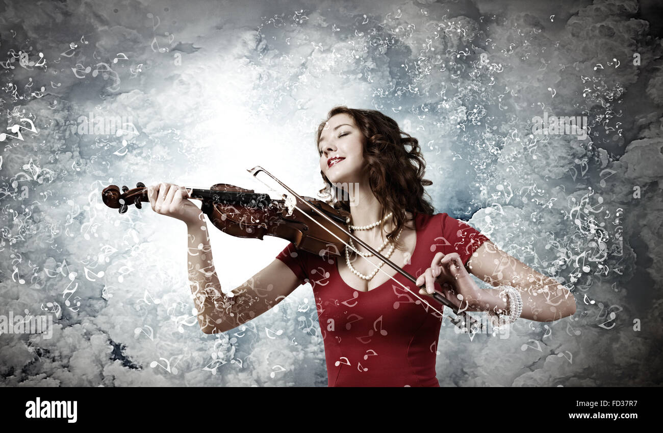 Young pretty woman in red dress playing violin Stock Photo - Alamy