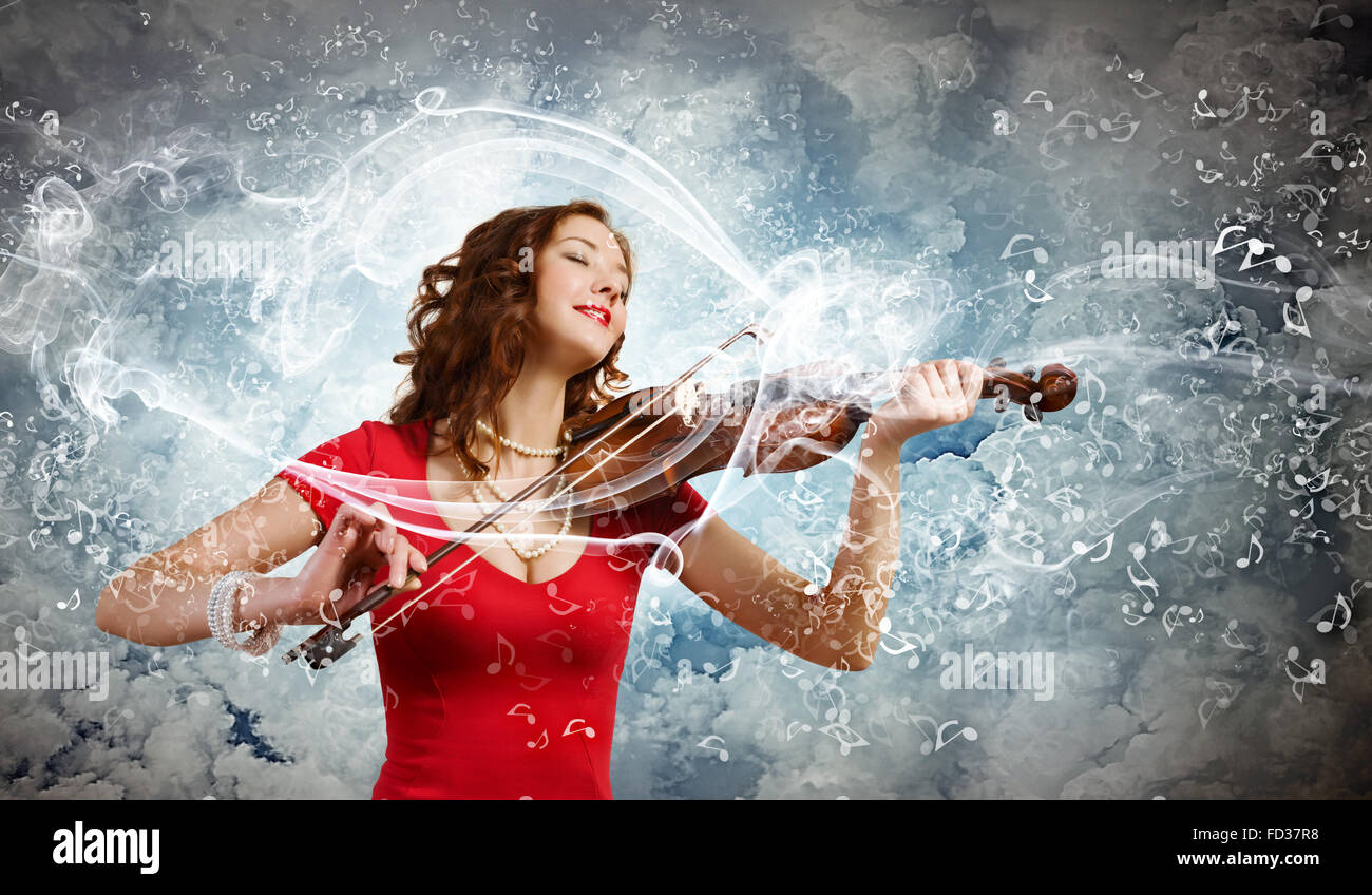 Young pretty woman in red dress playing violin Stock Photo - Alamy