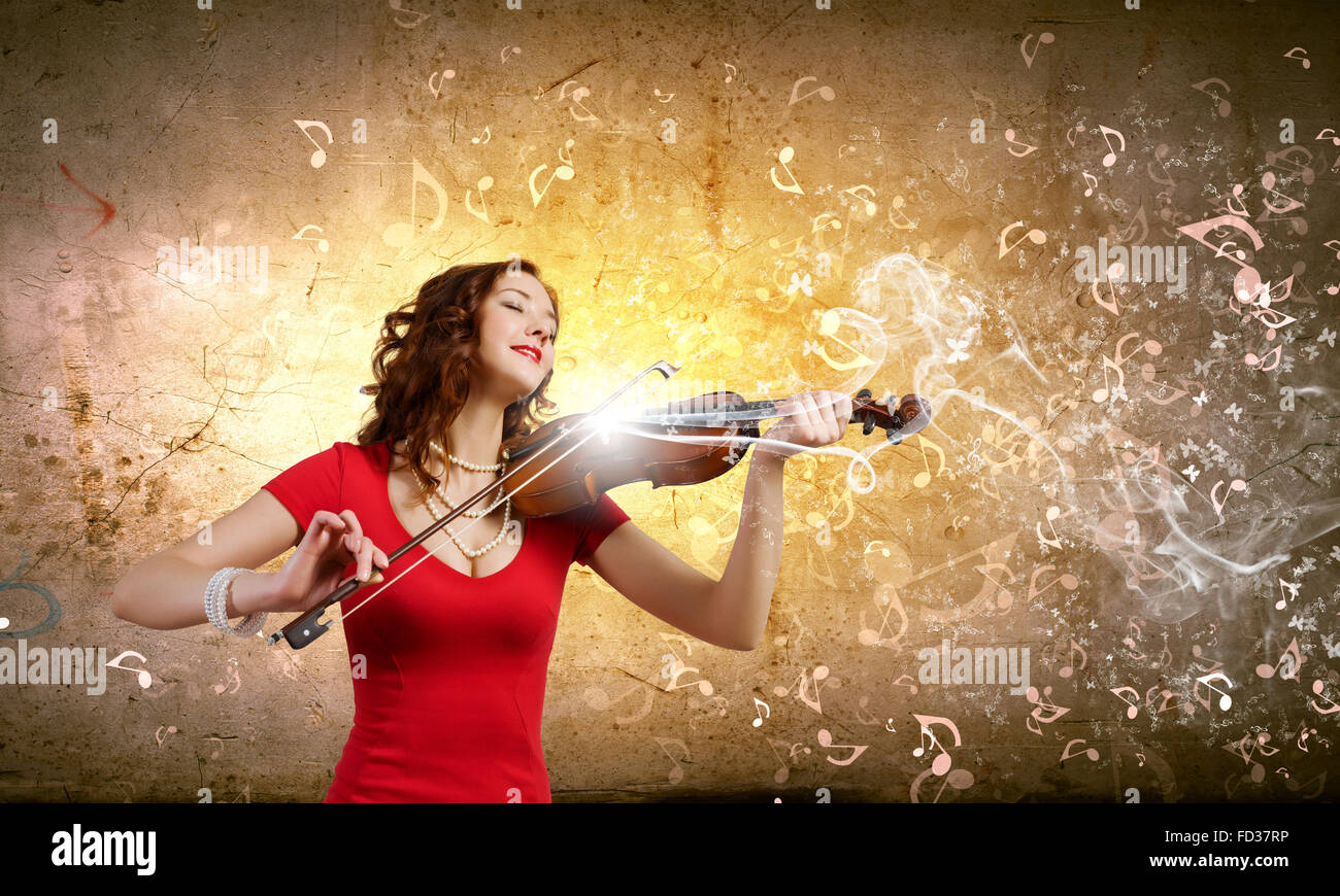 Young pretty woman in red dress playing violin Stock Photo - Alamy