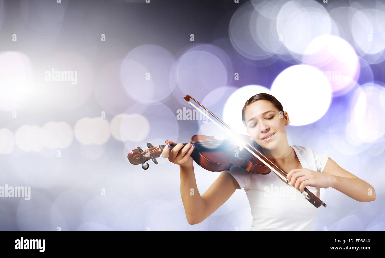 Portrait of young pretty woman playing violin Stock Photo - Alamy