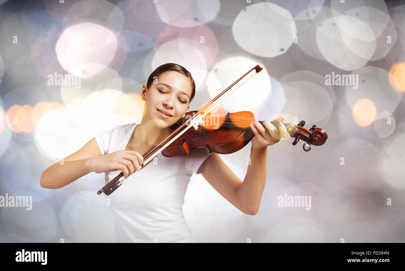 Portrait of young pretty woman playing violin Stock Photo - Alamy