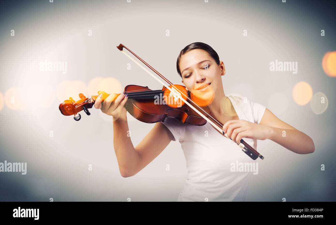 Portrait of young pretty woman playing violin Stock Photo - Alamy
