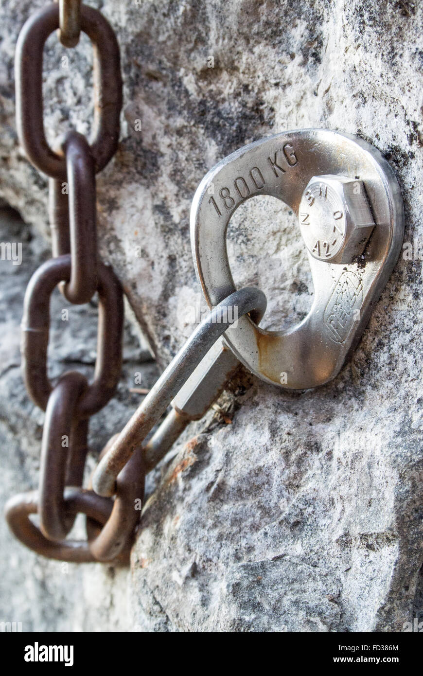 Expansion bolt and chain at the top of a rock face. Climbing Stock