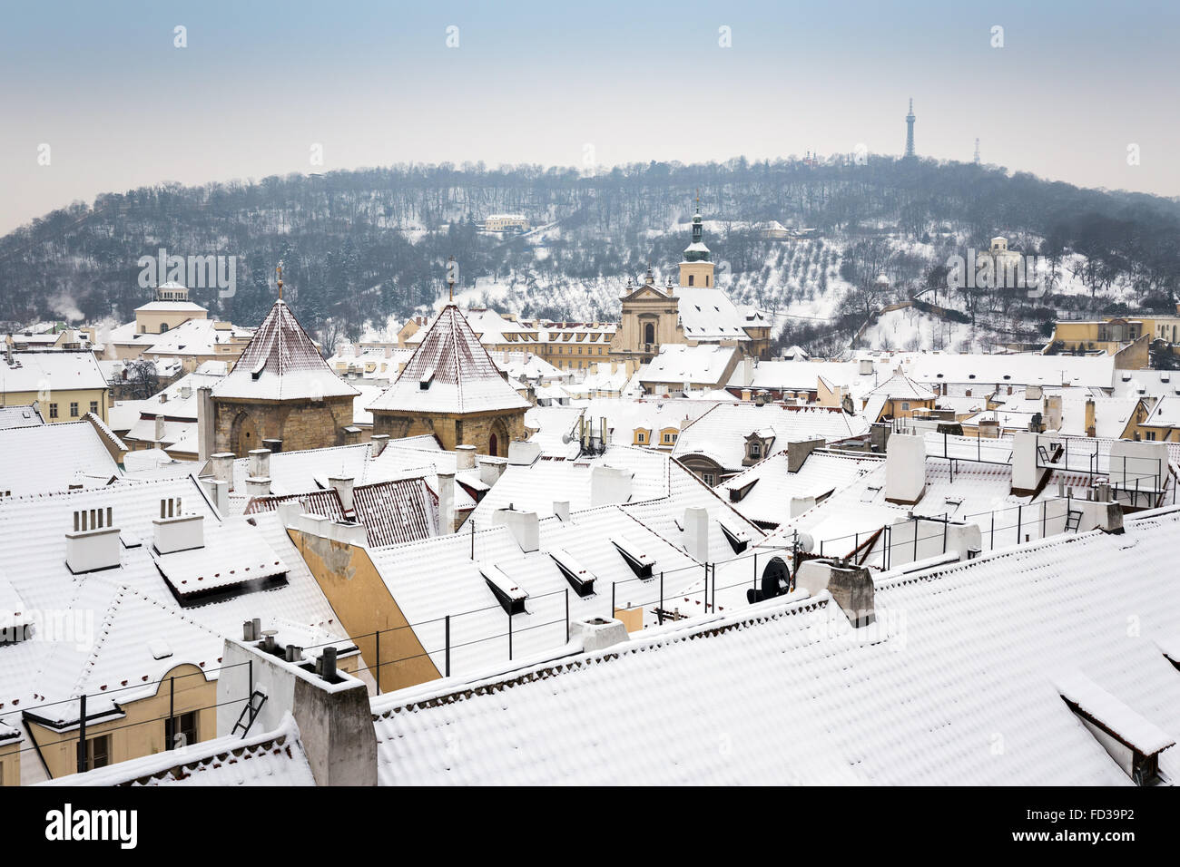 Snowy  roofs of the Lesser town Prague in winter, Petrin hill in background,  Czech republic, Europe Stock Photo