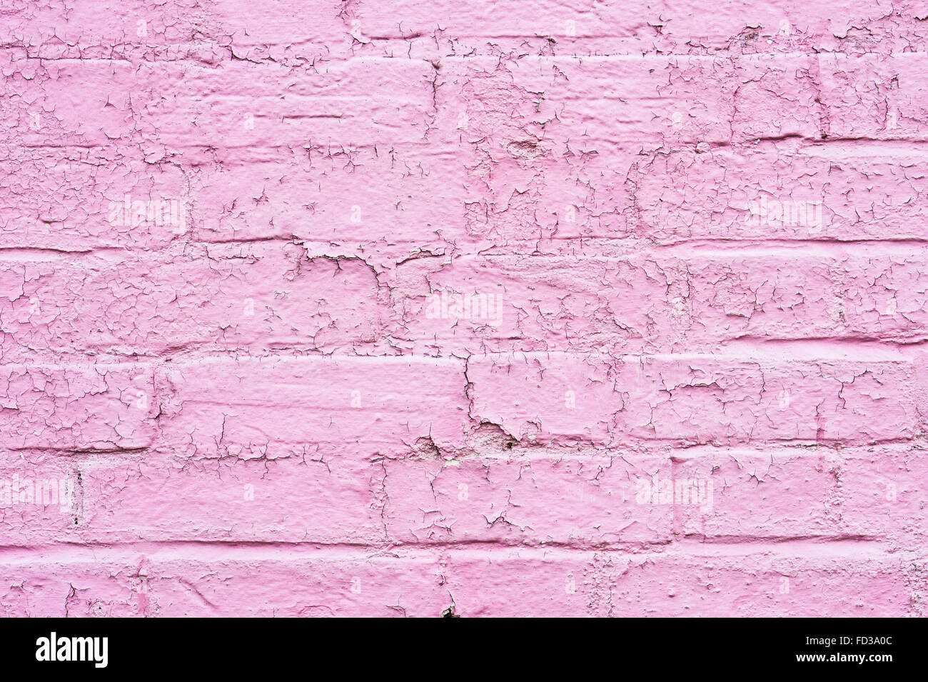 Peeling pink paint on a brick wall, as a background Stock Photo