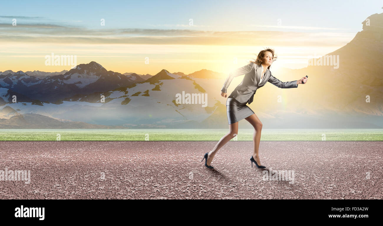 Young businesswoman in start position ready to run Stock Photo