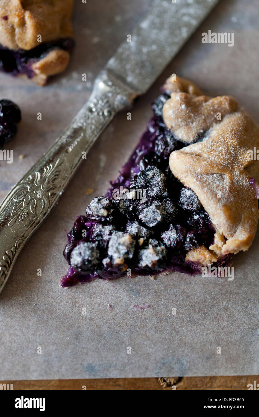 A slice of freshly baked Blueberry galette, dusted with powdered sugar Stock Photo
