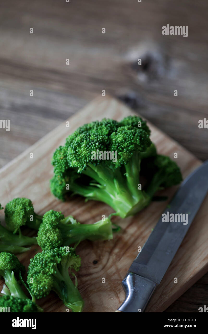 Cooked broccoli on a wooden cutting board Stock Photo