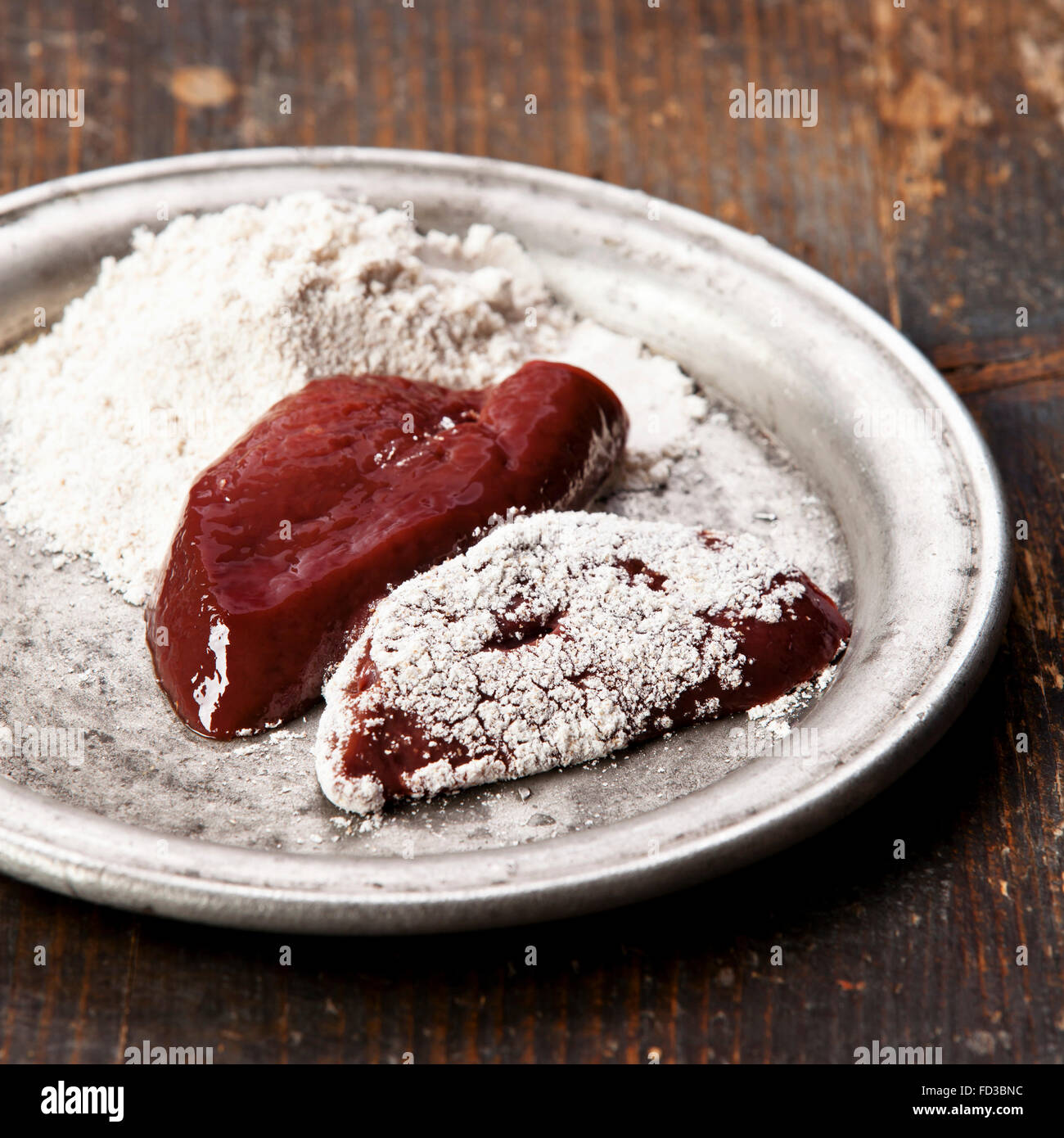 Raw liver sprinkled with flour Stock Photo