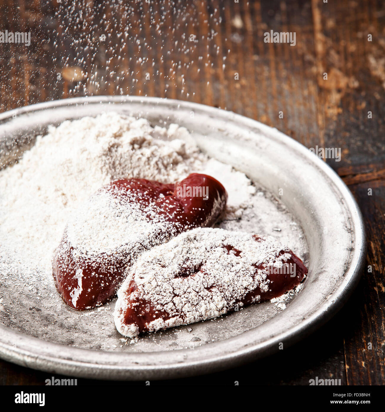 Raw liver sprinkled with flour Stock Photo