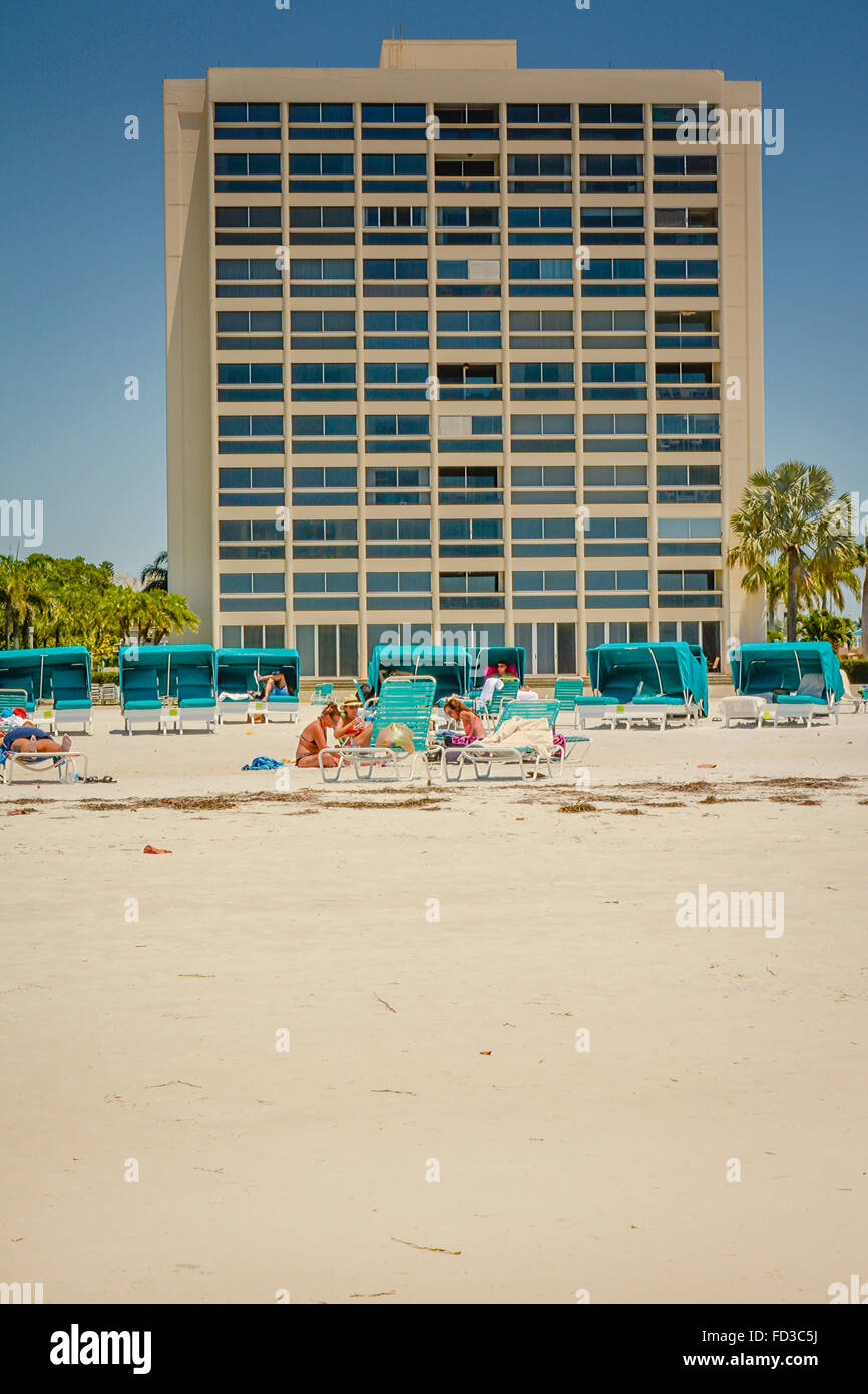 An architecturally dated condominium complex for vacation rentals sits right on the beach for guests to enjoy a beach holiday Stock Photo