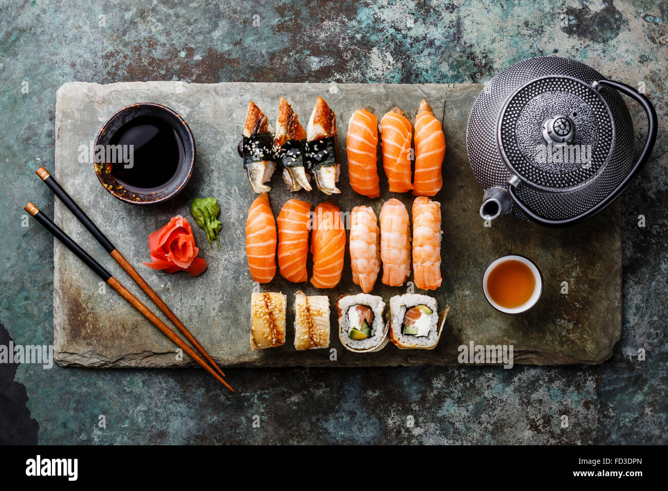 Sushi Set with tea served on gray stone slate on metal background Stock Photo