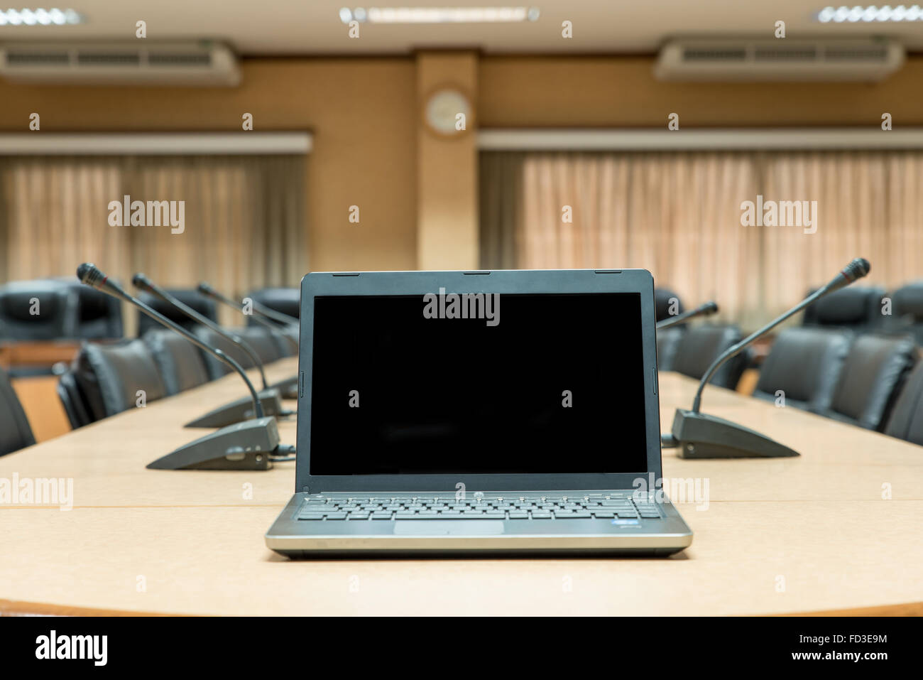 Before a conference,Laptop in front of empty chairs at conference room Stock Photo