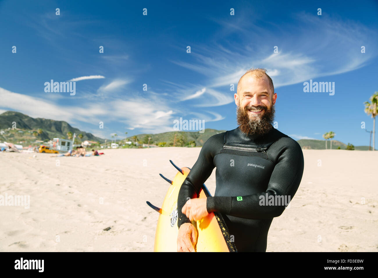 A surfer just out of the water on a Malibu beach, California. Stock Photo