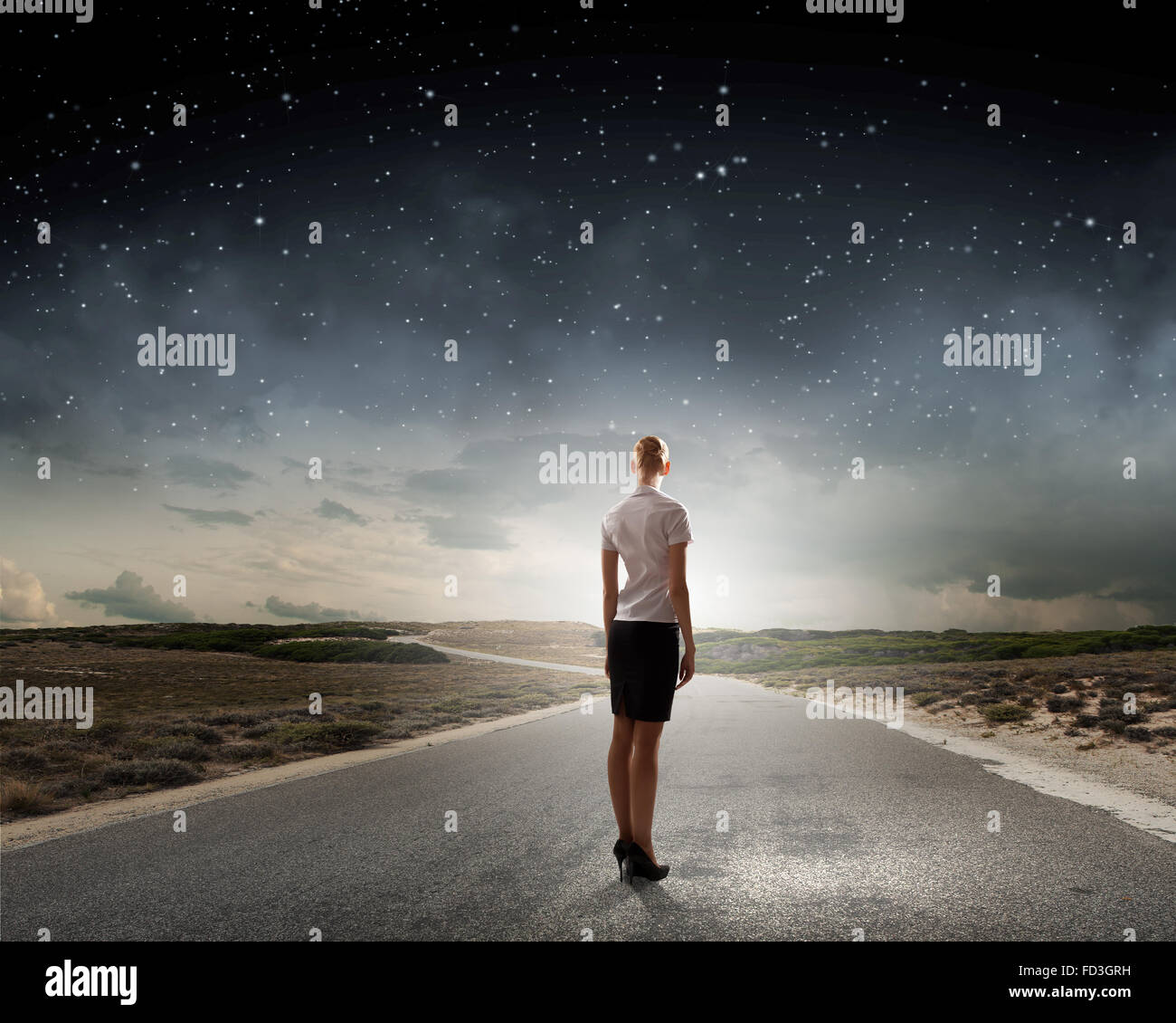 Back view of businesswoman standing on road and looking far away Stock ...