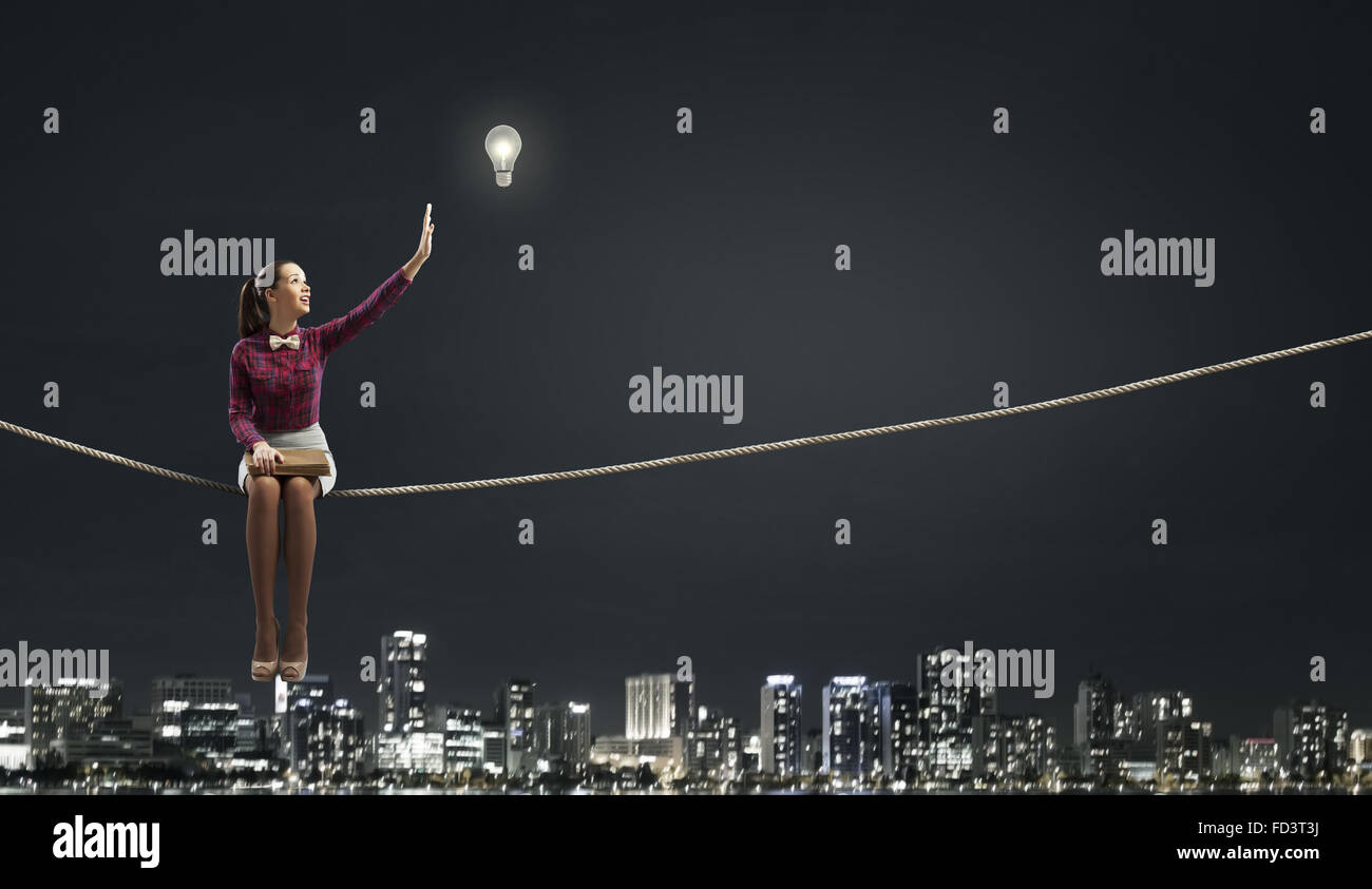 Sitting Rope Relax Young beautiful lady sitting on rope and reading book Stock Photo - Alamy