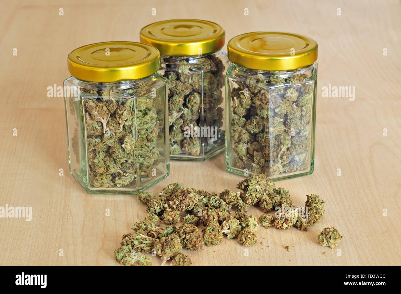 Dry cannabis buds stored in a glass jars Stock Photo