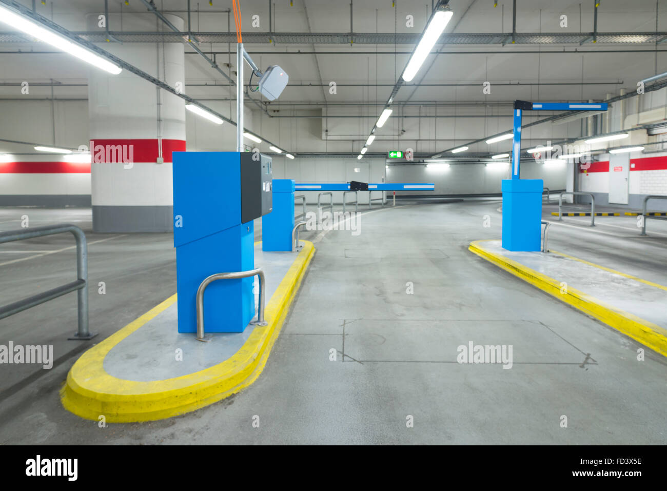 Exit lane of a parking garage with barrier and ticket machines Stock Photo