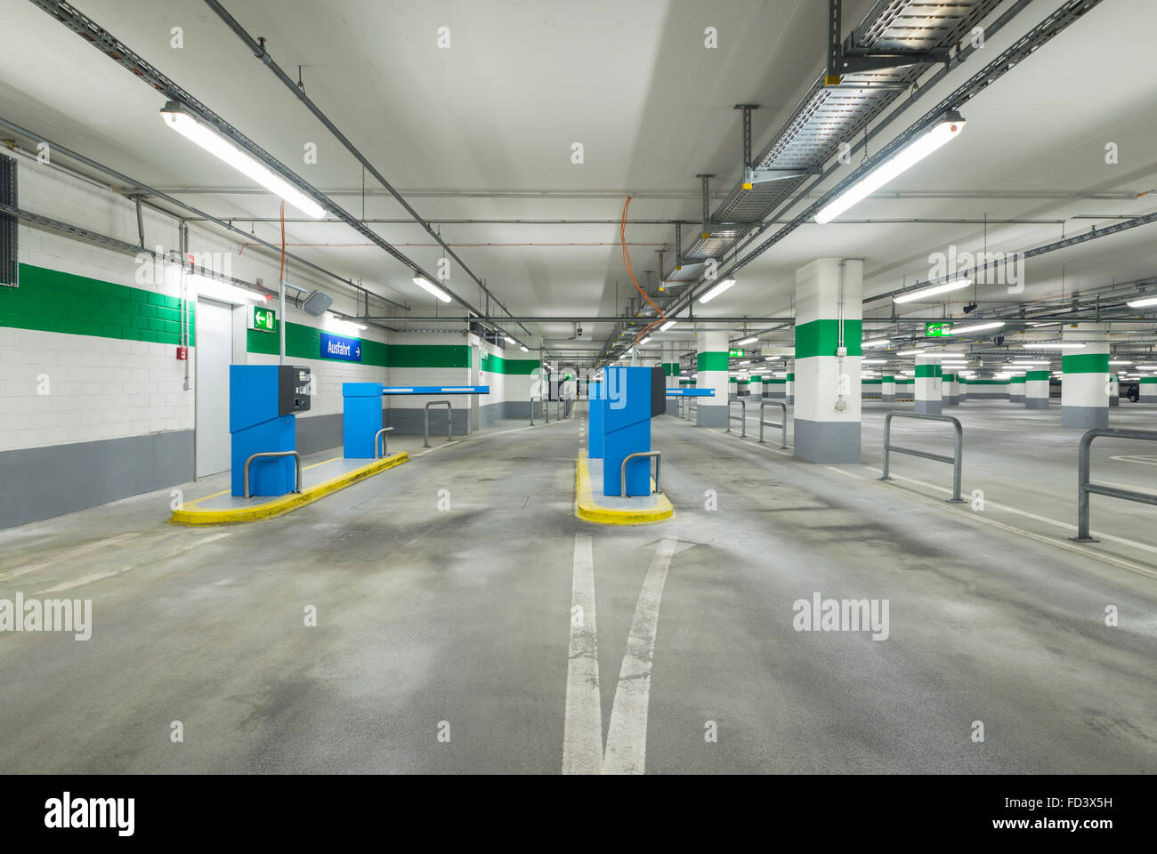 Entrance lane of a parking garage with barrier and ticket machines