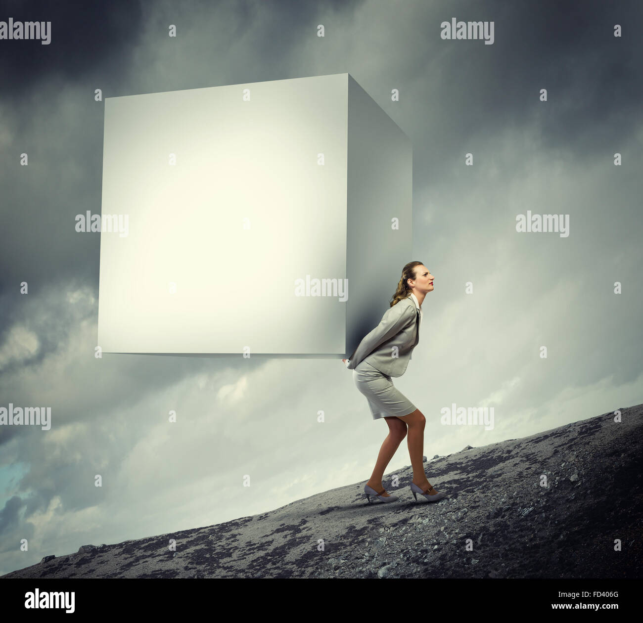 Image of businesswoman carrying big white cube on her back. Place for text Stock Photo
