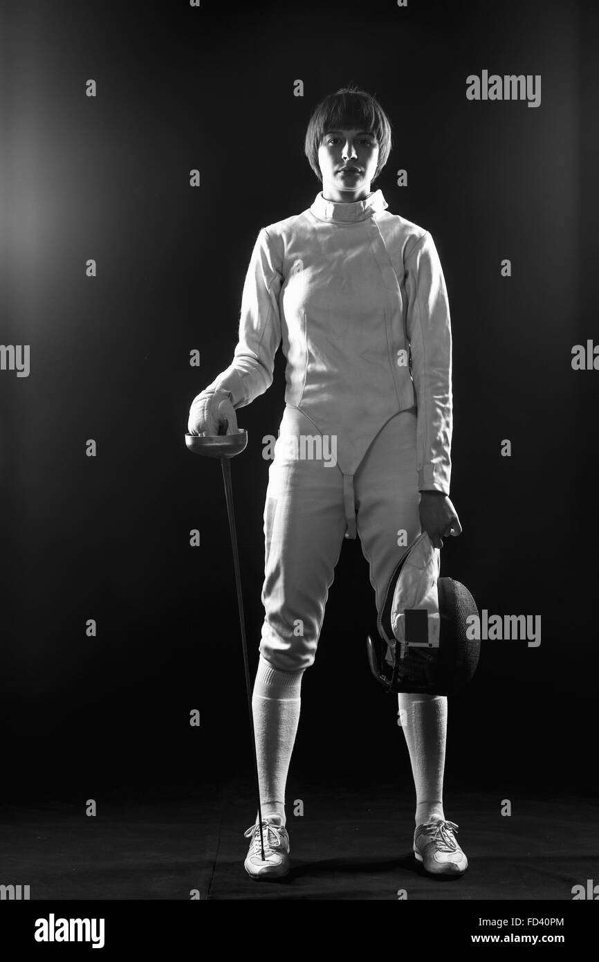 The portrait of woman wearing white fencing costume  on black Stock Photo