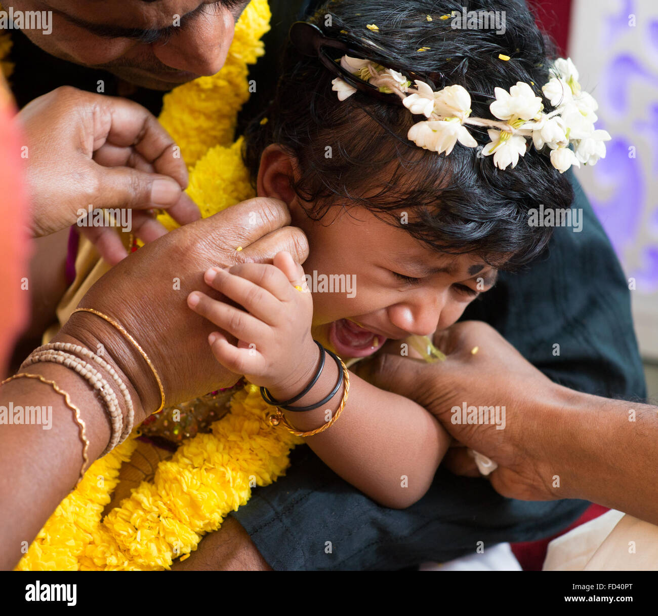 Baby girl crying during the karna vedha events. Traditional Indian