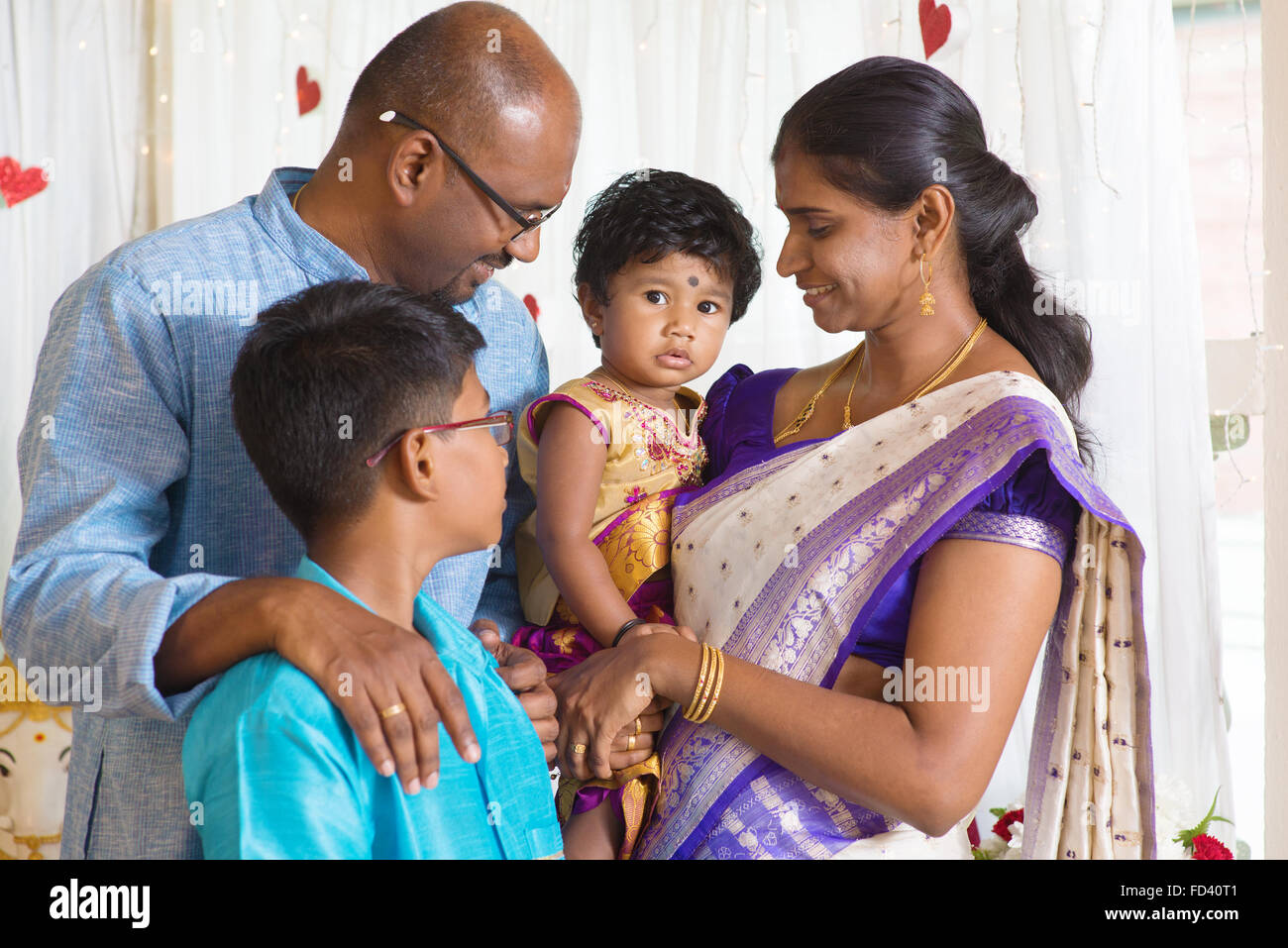 Traditional India family portrait. Indian parents and children in a blessing ceremony. Stock Photo