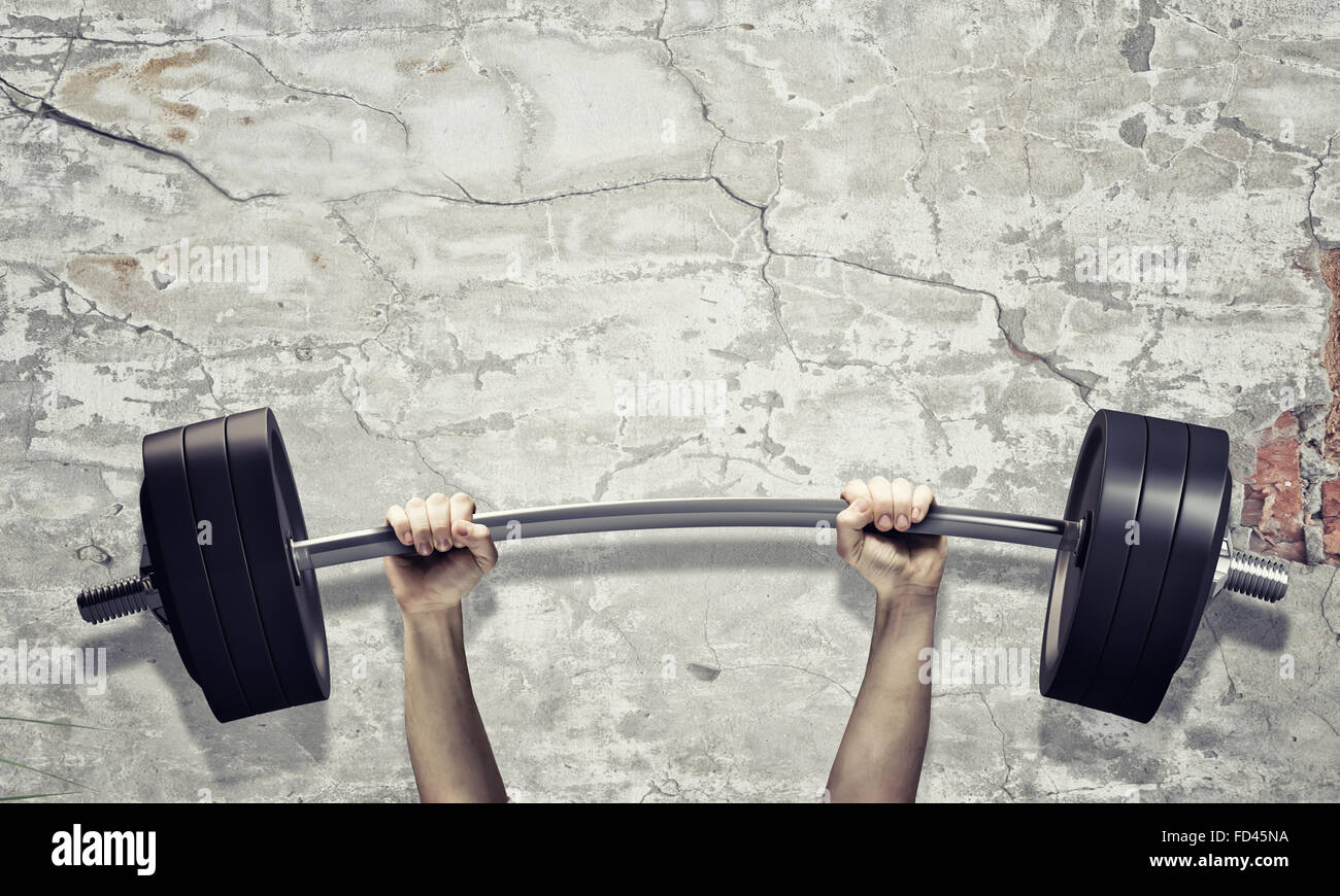 Lifting barbell above head. Strength and power Stock Photo Alamy