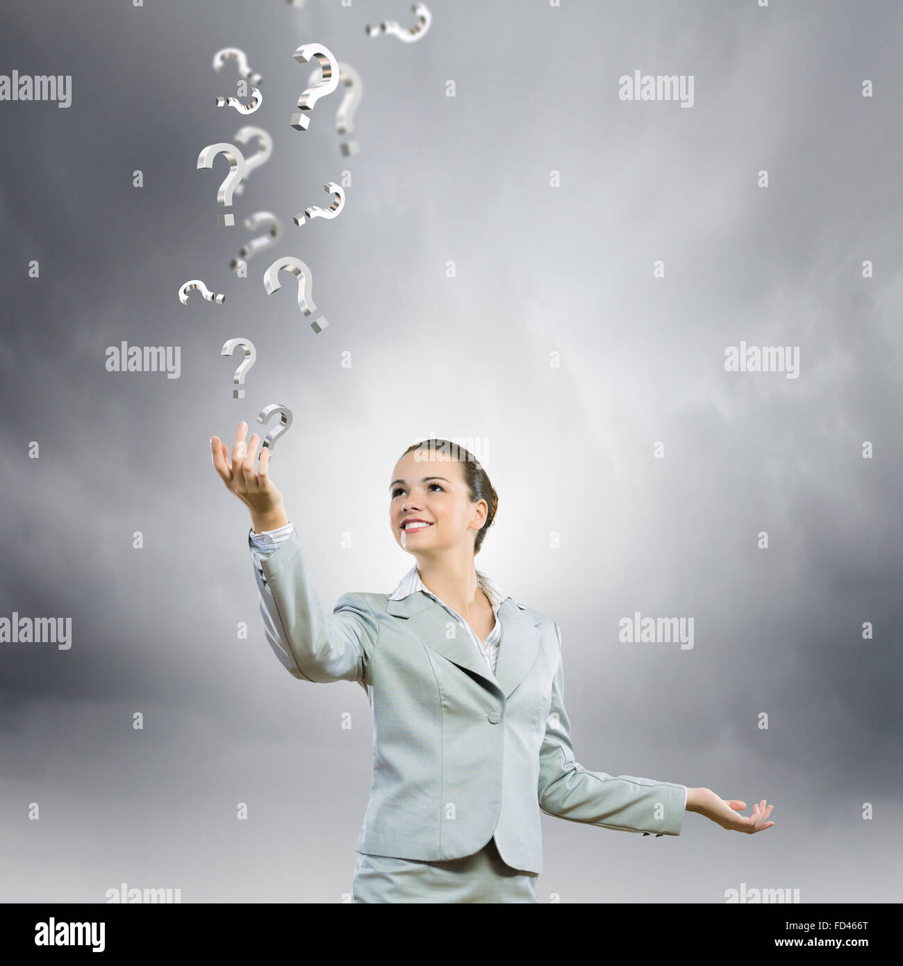 Image of young attractive businesswoman holding question marks in hand ...