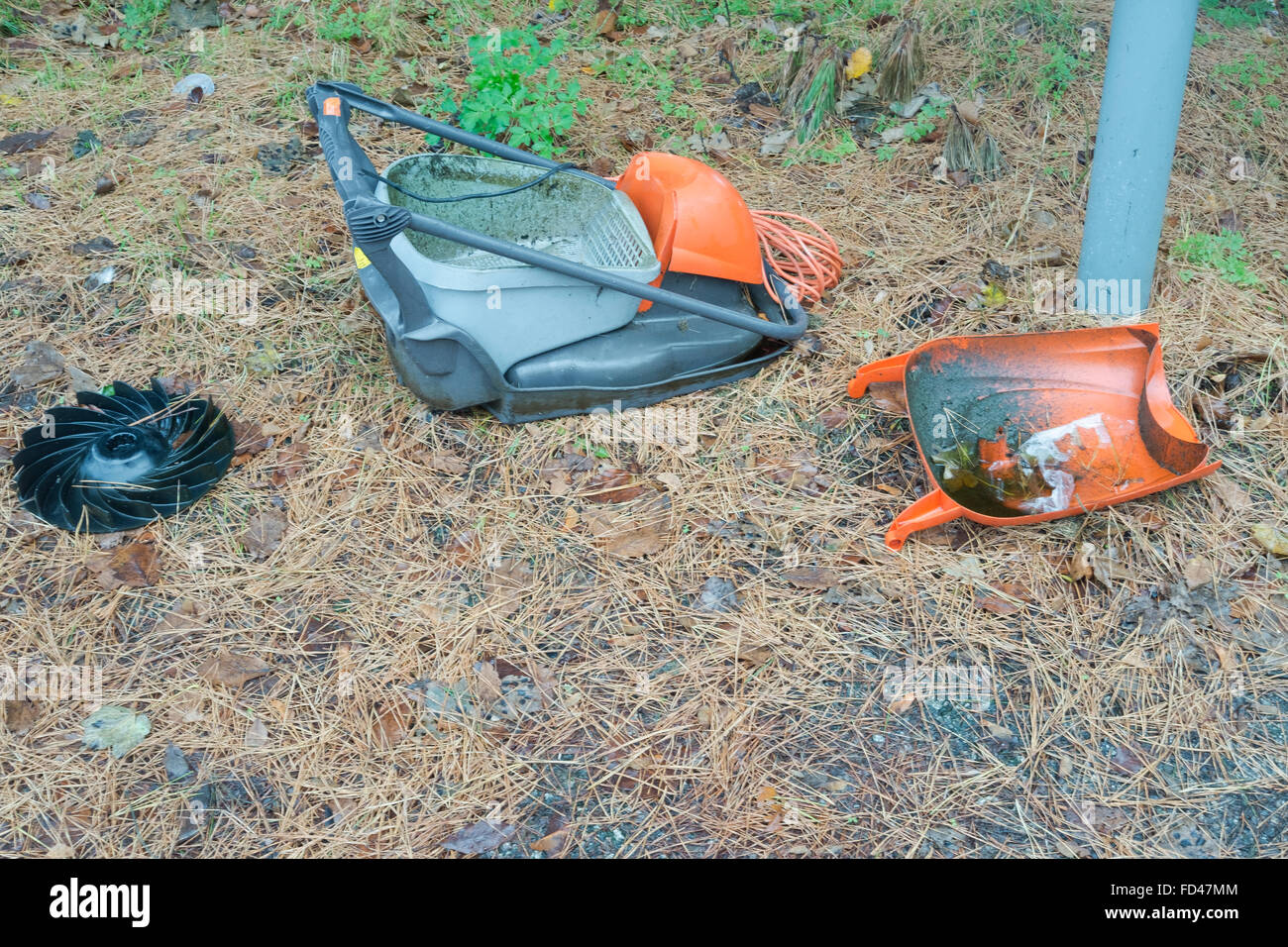 A Flymo lawnmower left in bits by the side of a road Stock Photo
