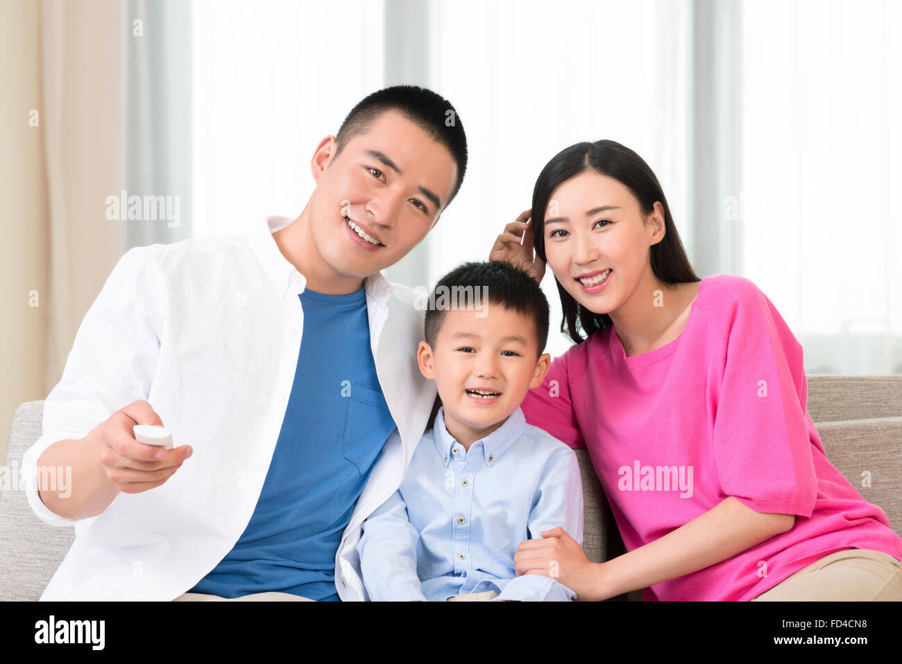 Young family watching TV Stock Photo