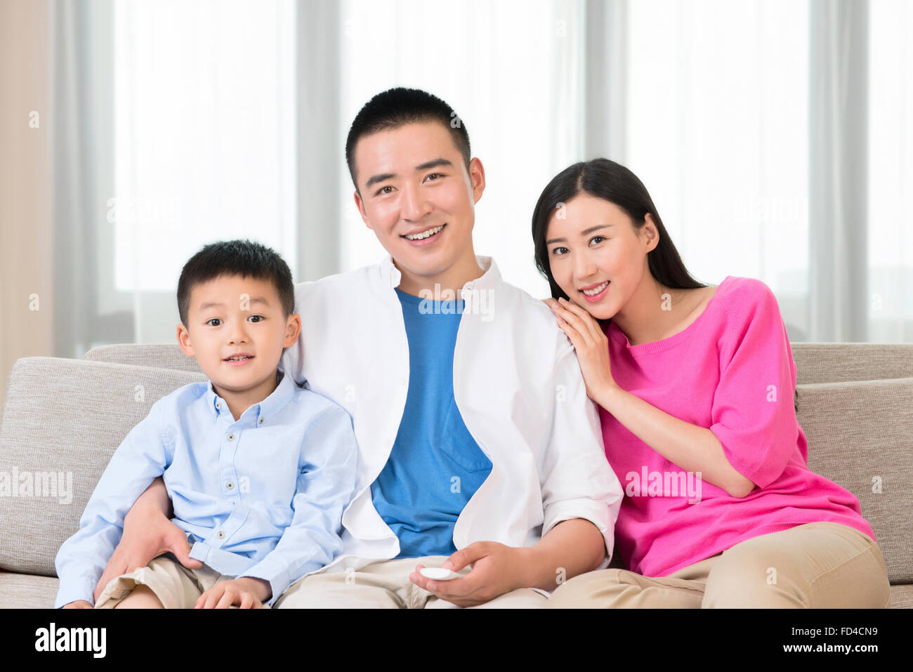 Young family watching TV Stock Photo