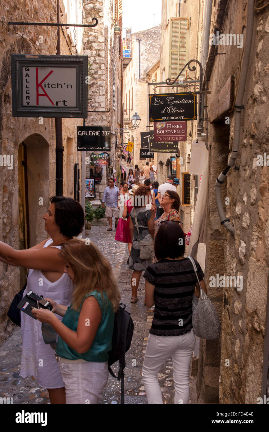 Tourists in the town centre of the bustling visitor destination St Paul de Vence, near Nice France. Stock Photo
