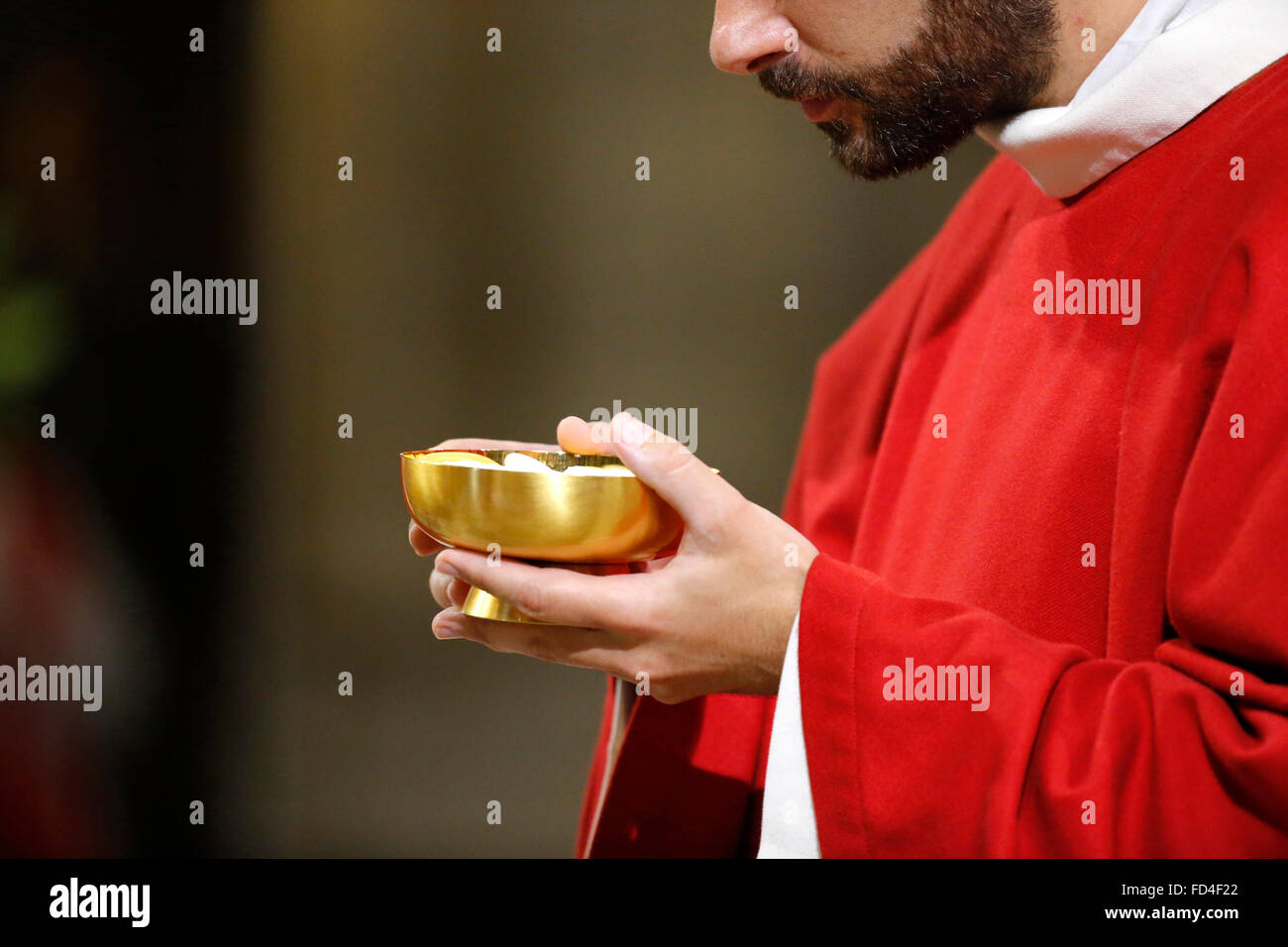 Catholic priest giving holy communion. Stock Photo