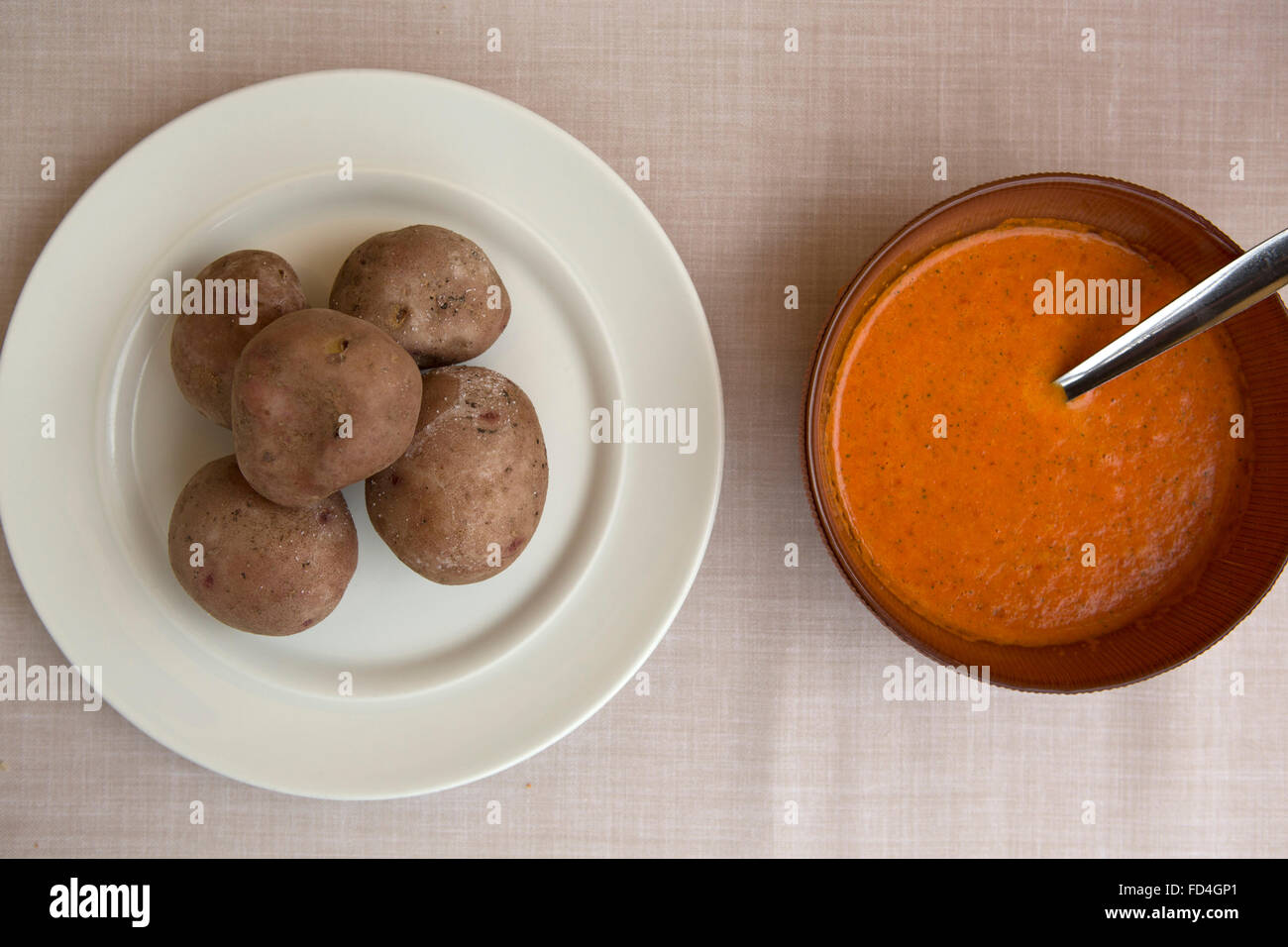 Potatoes (papas arrugadas) and mojo rojo served in Tenerife, Spain. The foods are all traditional Canarian dishes. Stock Photo