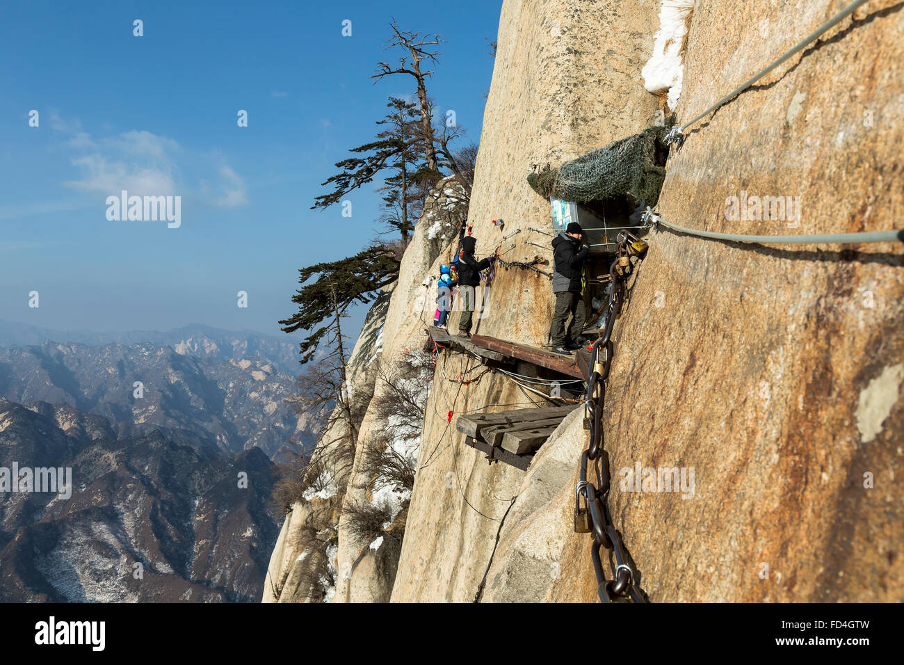 Hikers walking on the Danger Trail of Mount Hua Shan Stock Photo