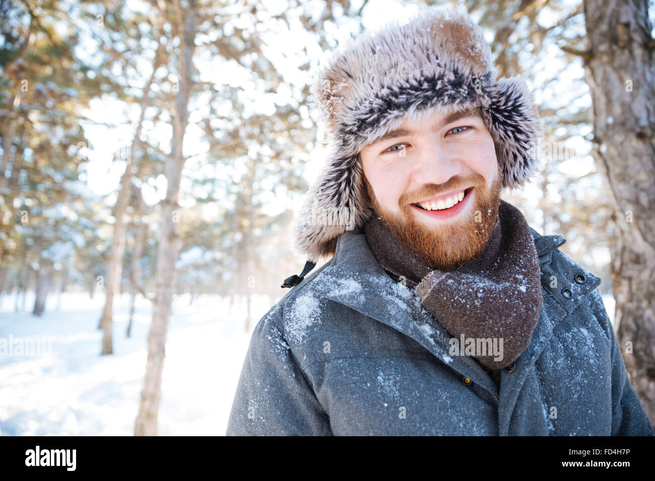 Happy young man looking at camera in winter ark Stock Photo
