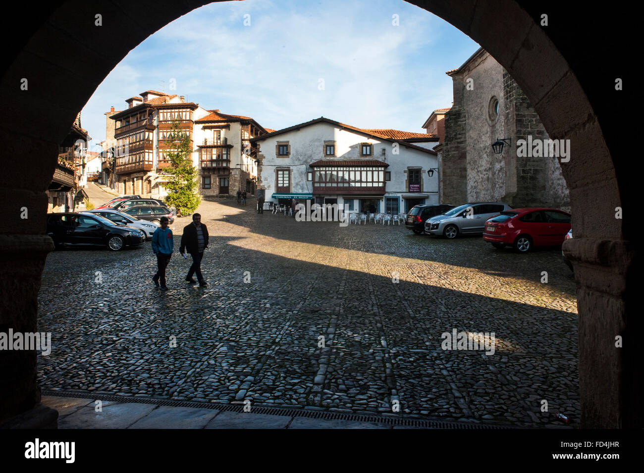 View of one of the squares in the town of Comillas (Cantabria) from one of the arches. One of the towns most visited by tourists Stock Photo