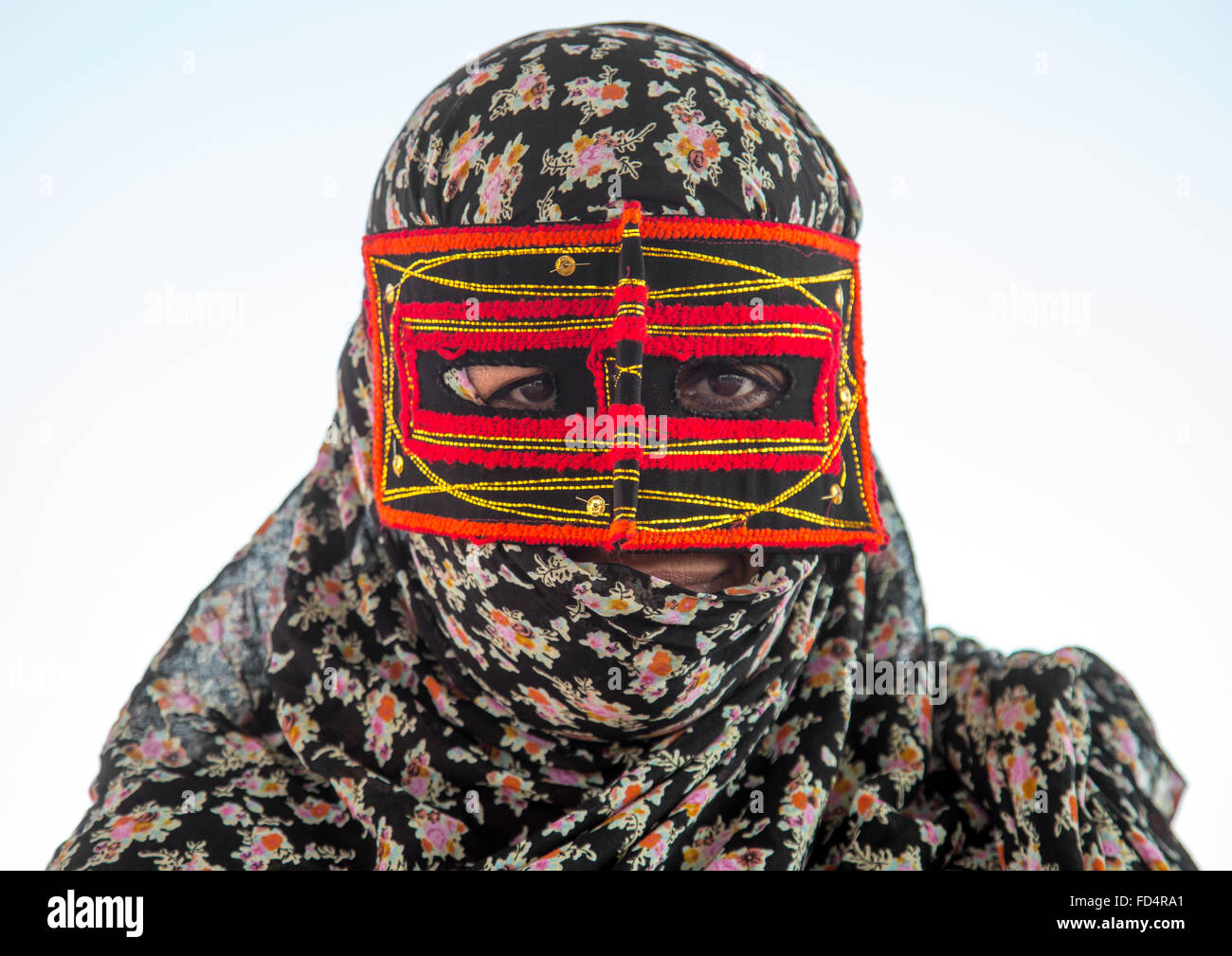 a bandari woman wearing the traditional mask called the burqa on a market, Hormozgan, Bandar Abbas, Iran Stock Photo