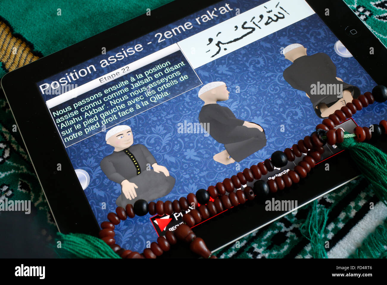 Teaching of the five islamic daily prayers (Salat) on an Ipad. Stock Photo