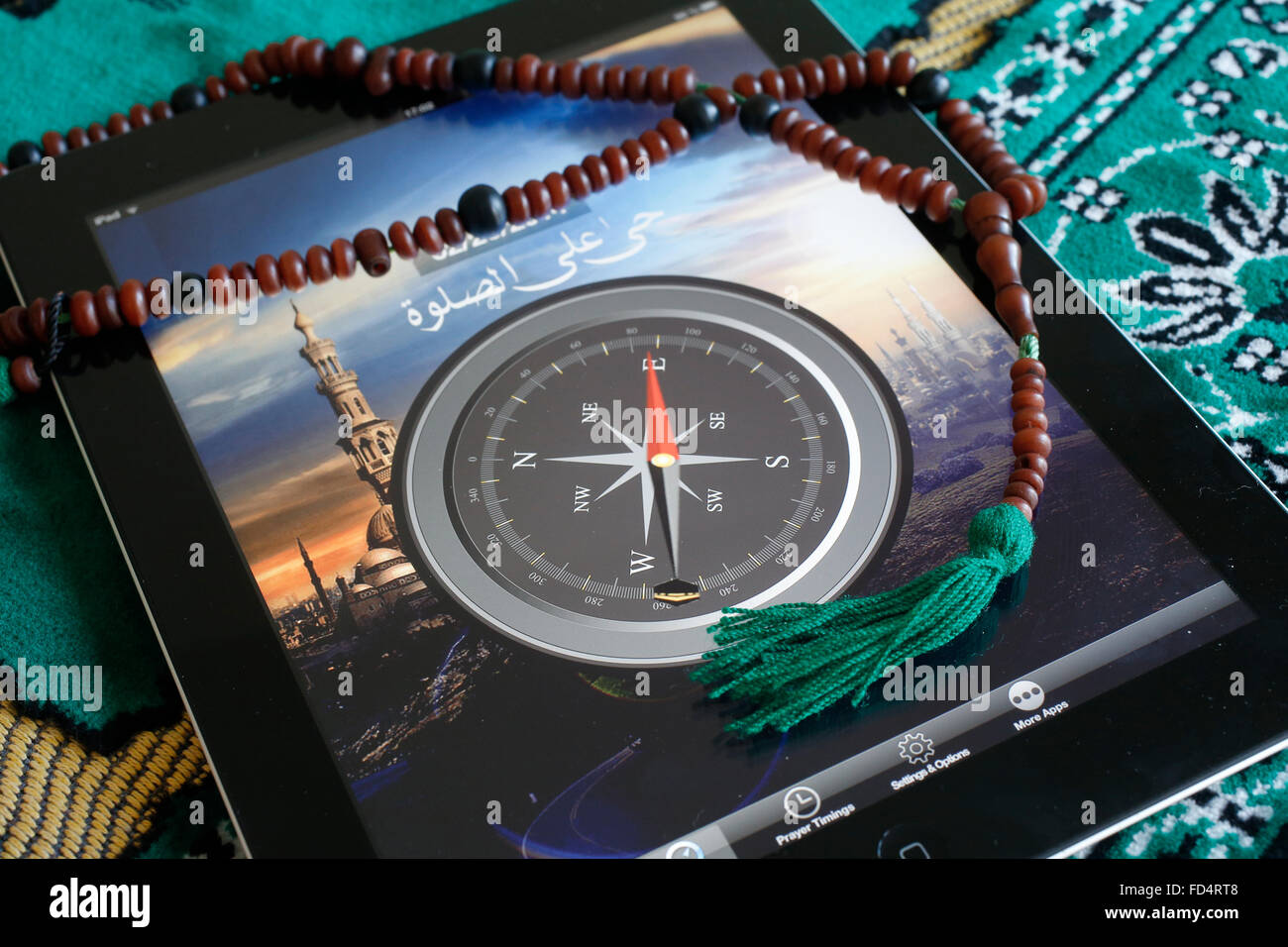 Islamic compass on an Ipad. Qibla compass used by Muslims to indicate the direction of Mecca. Stock Photo